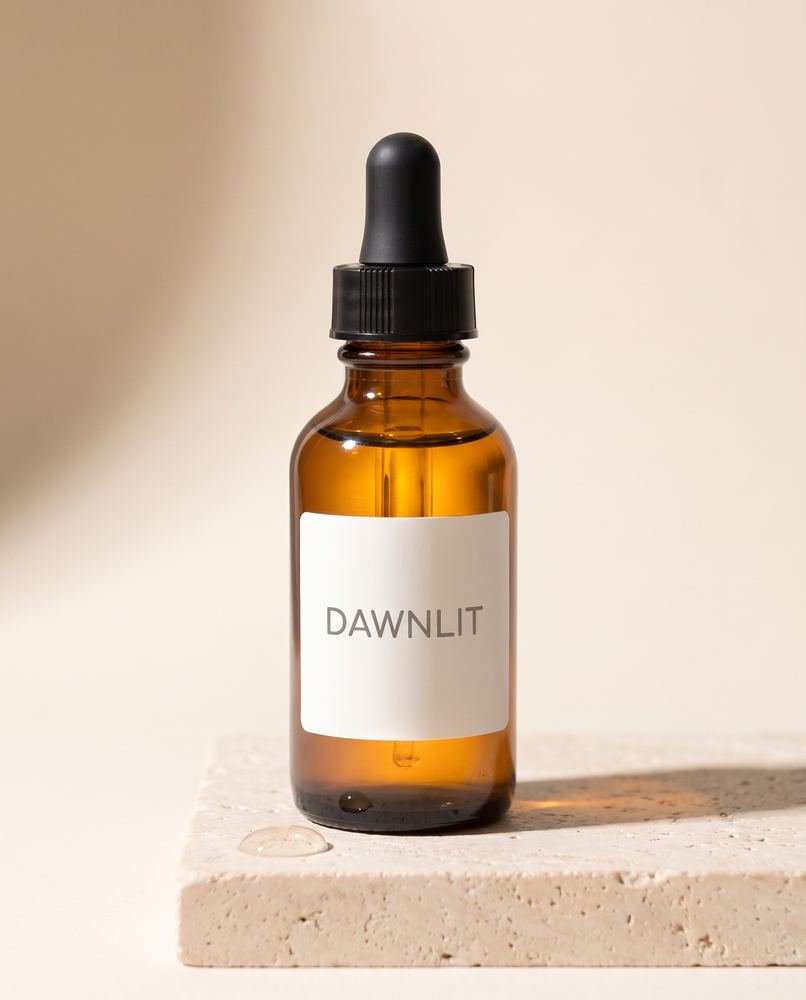 Dawnlit serum hero shot on stone